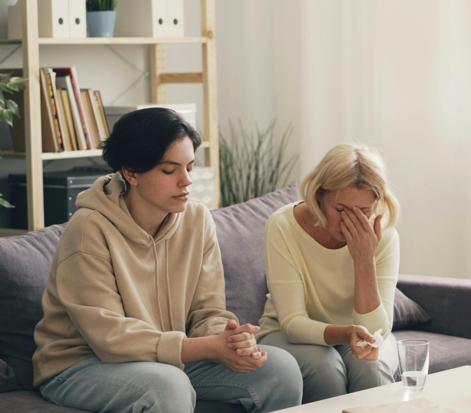 Emotional family therapy session with a therapist indoors, conveying connection and support.